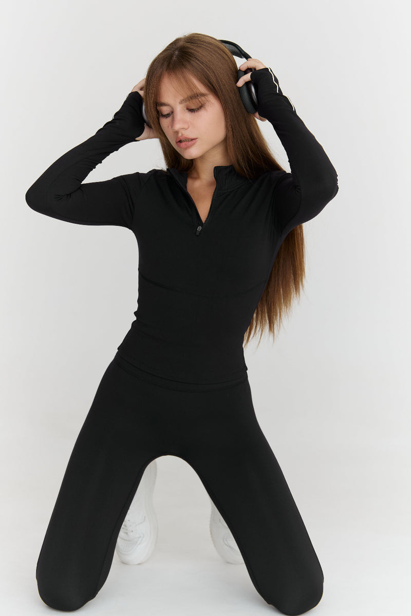 Woman wearing a black outfit on a white background