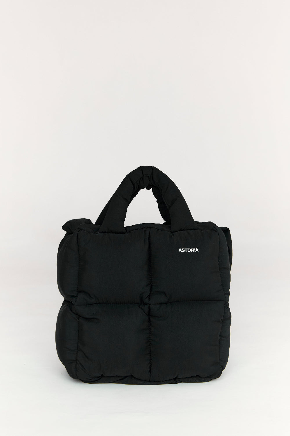 Black puffer backpack with 'Aekyung' branding on a white background